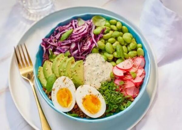 Table set with balanced bowls of vegetables, grains, and toppings